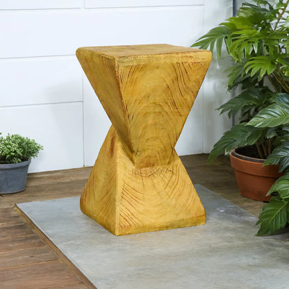 Sculptural golden pyramid end table for garden or porch decor on a sleek tiled floor.