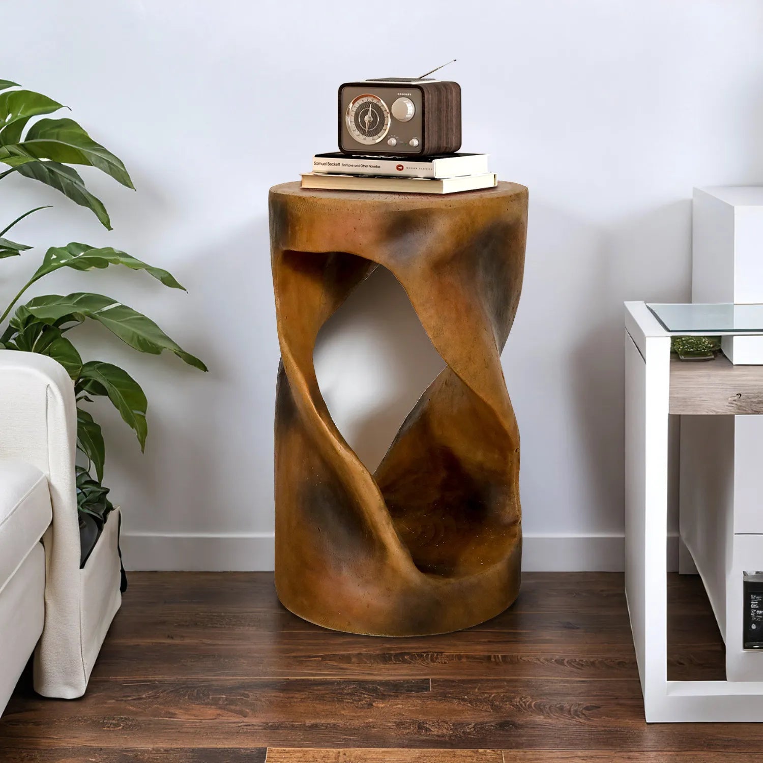 Spiral pedestal table used as a functional end table for a vintage radio in a cozy corner.