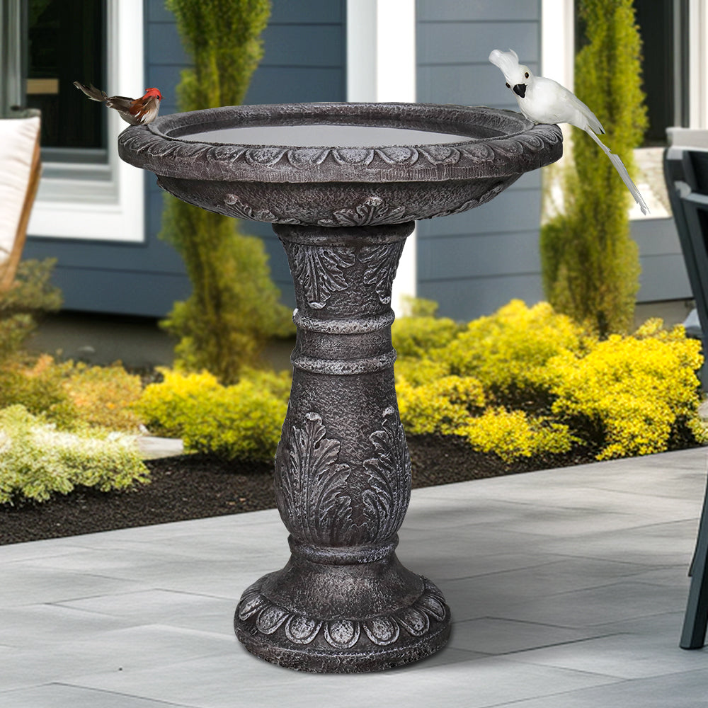 Stone-like concrete birdbath in a peaceful backyard