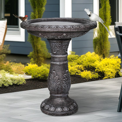 Stone-like concrete birdbath in a peaceful backyard