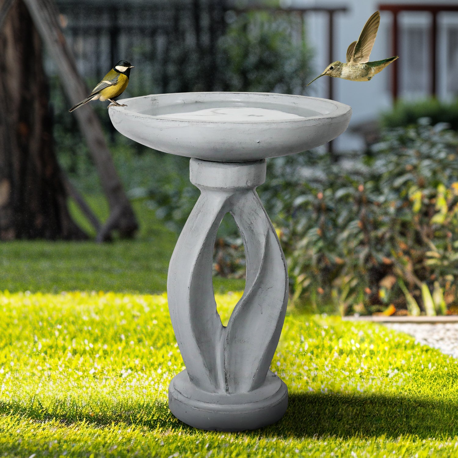 Sturdy 13.5kg concrete birdbath with geometrical pedestal providing a tranquil oasis in a shaded garden.