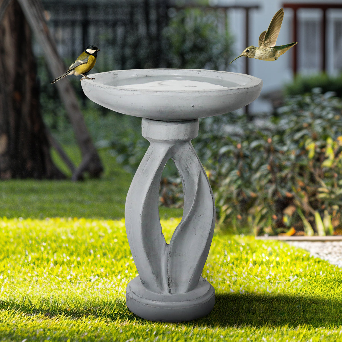 Sturdy 13.5kg concrete birdbath with geometrical pedestal providing a tranquil oasis in a shaded garden.
