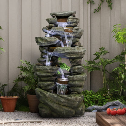 Sturdy 46.5kg poly-resin rock outdoor fountain placed elegantly against a backyard fence.