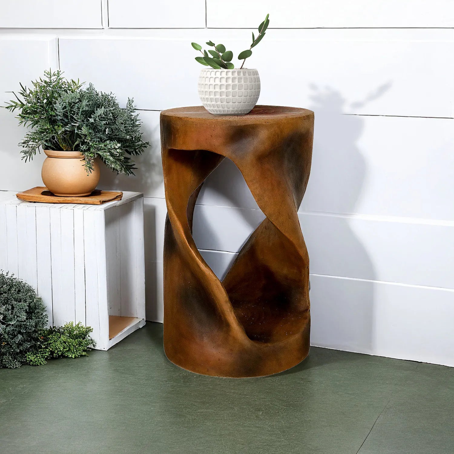Weatherproof outdoor side table with a spiral design on a green patio floor.