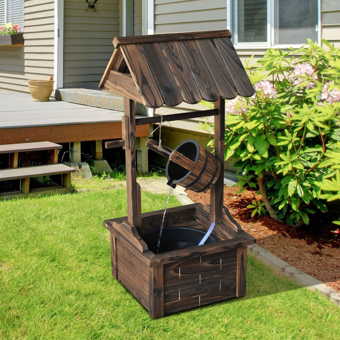 Carbonized Wood Wishing Well Outdoor Fountain 44 Inch in garden setting