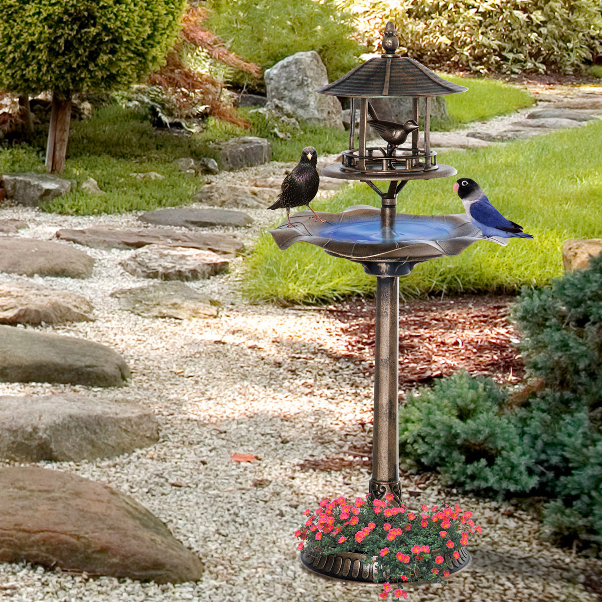 birdhouse verdigris bird bath standing in a zen garden beside a stone path