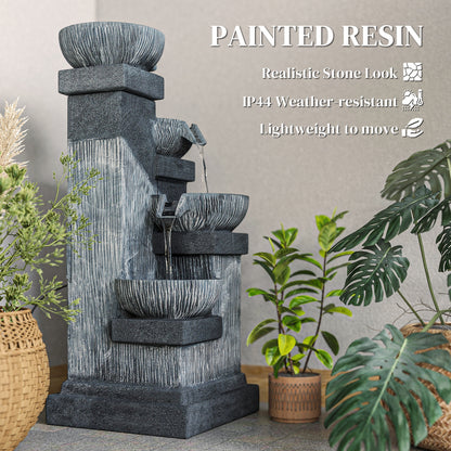 charcoal bowl tower fountain surrounded by tropical foliage