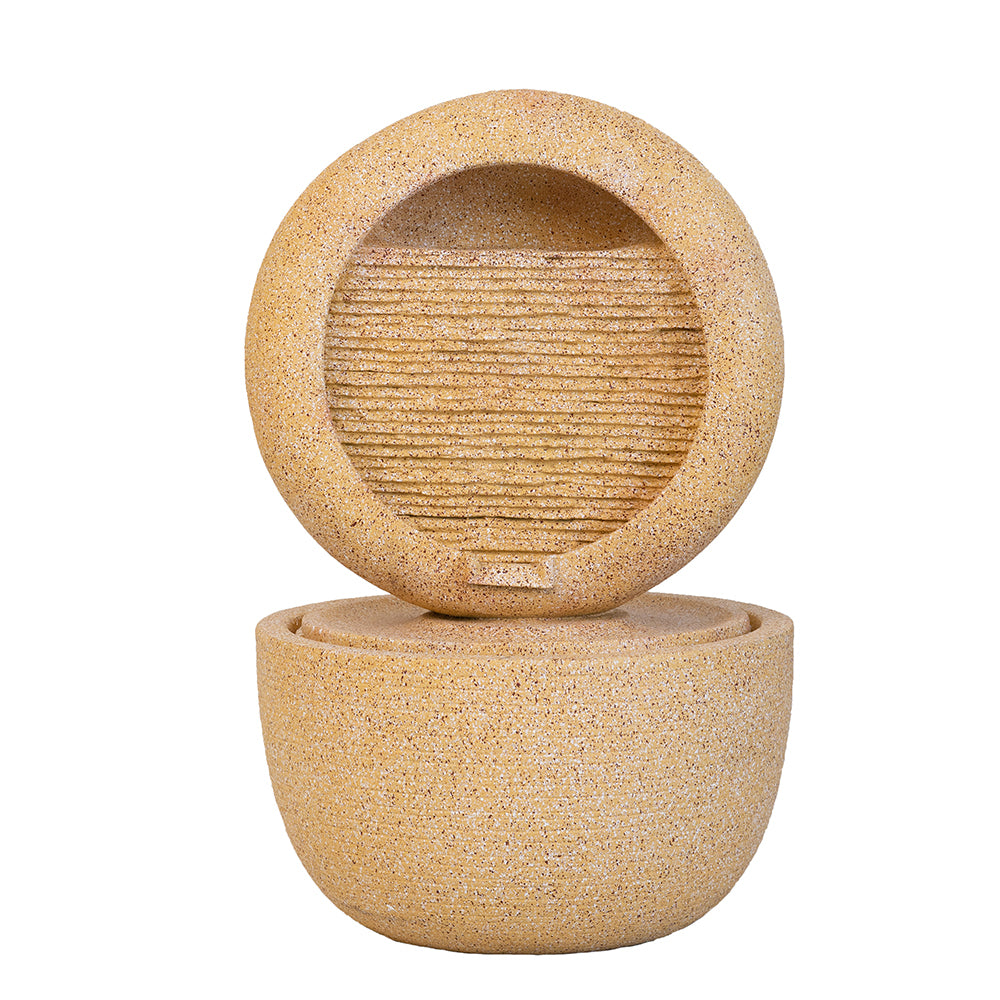 cream cement halo fountain with ribbed cascade face over round basin
