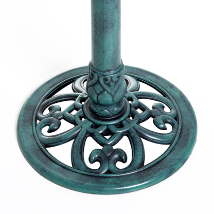 fleur-de-lis scrollwork detail on green verdigris bird bath base