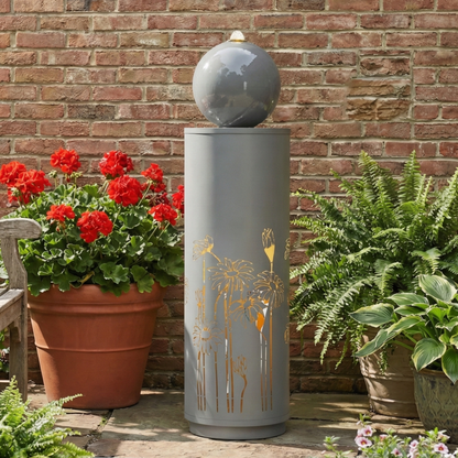 gilded vine cutout sphere fountain beside red geranium flowers