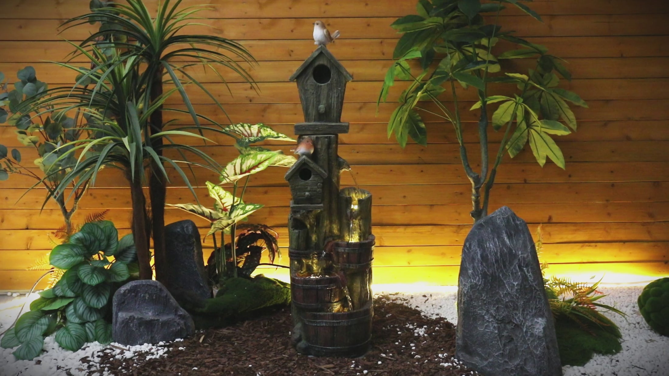 Video showing the soothing cascading water flow and lighting of the rustic birdhouse fountain.

