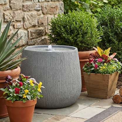 rippled basin bubbler fountain among terracotta flower pots