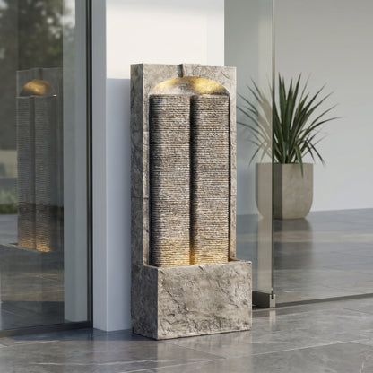 split slate column fountain by an entryway with potted plant