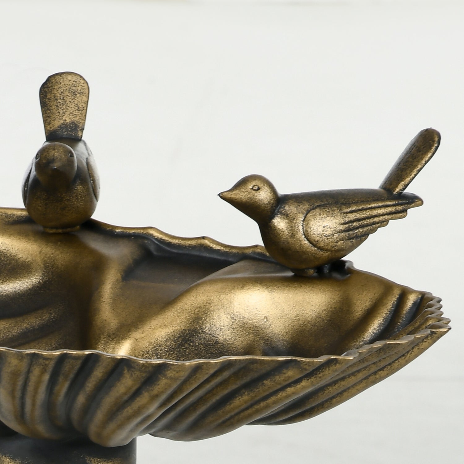 twin sculpted songbirds on shell basin detail of antique bronze bird bath