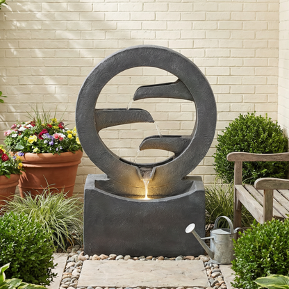 zen ring cascade fountain surrounded by garden greenery