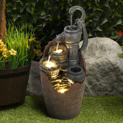 32.6 inch tall retro hand pump and barrel fountain in a rustic garden setting