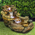 39" wide panoramic creek outdoor fountain nestled among garden rocks and greenery