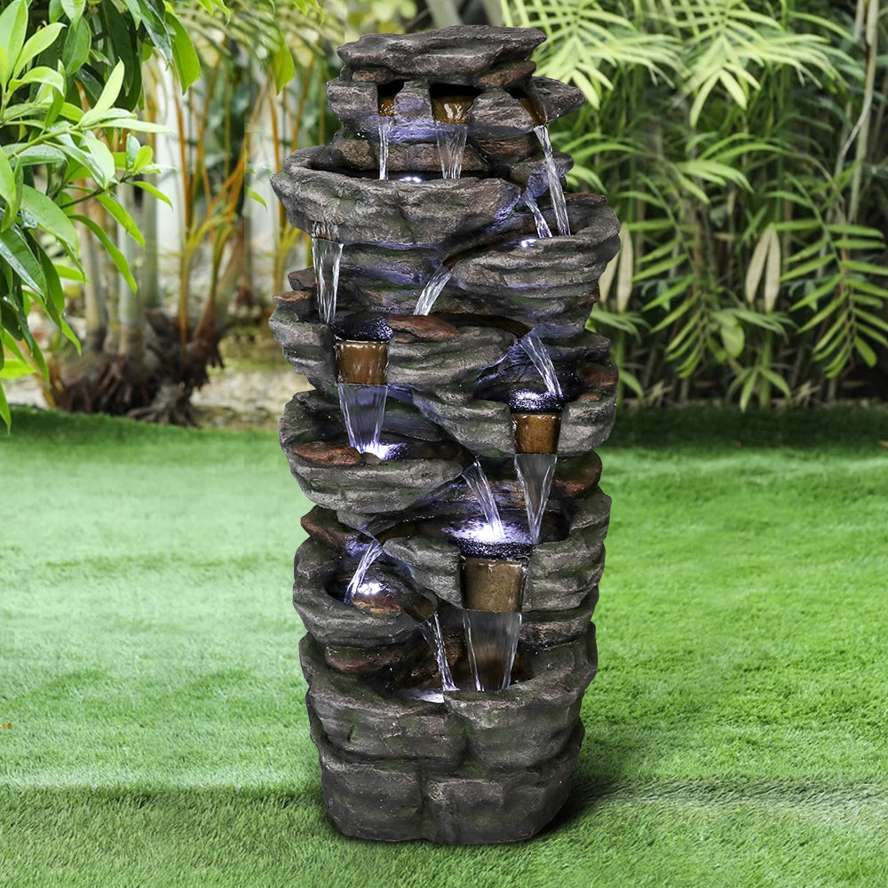 47.2 inch tall 9-tier cascading rock fountain creating a natural waterfall in a large garden
