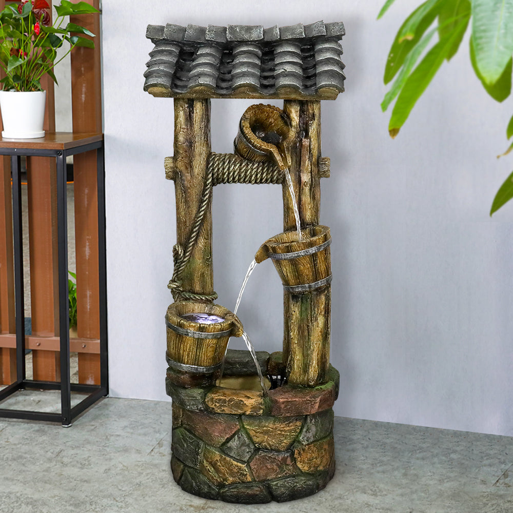 Cascading bucket fountain serving as a nostalgic centerpiece for a rustic patio