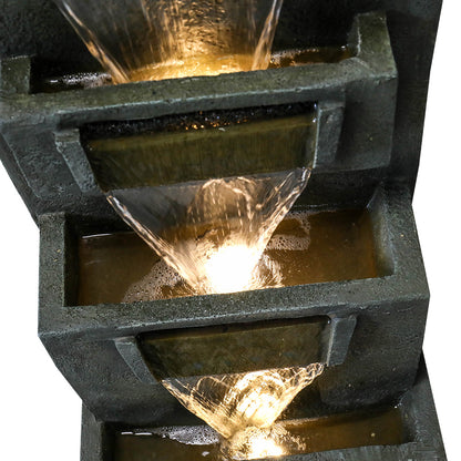 Close-up of the smooth water flow cascading from the top square tier