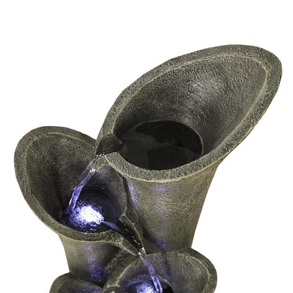 Close-up of the soothing natural water flowing gracefully from the top stone tiers