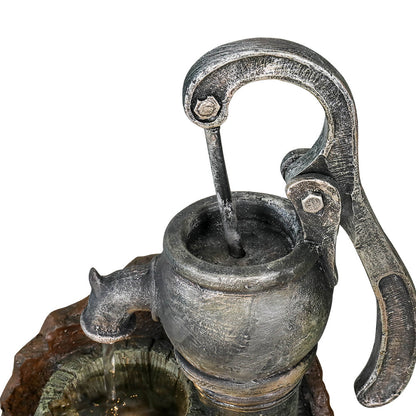 Close-up of the vintage hand pump spout and trickling water flow