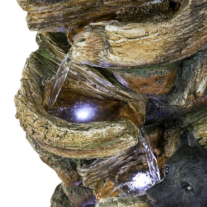 Detailed shot of the adorable resin bears climbing the tree trunk fountain