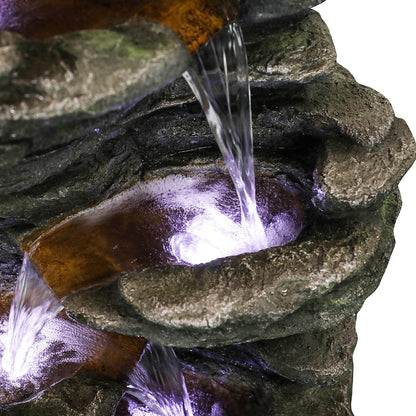 Detailed shot of the soothing cascading water trickling down the realistic stone tiers