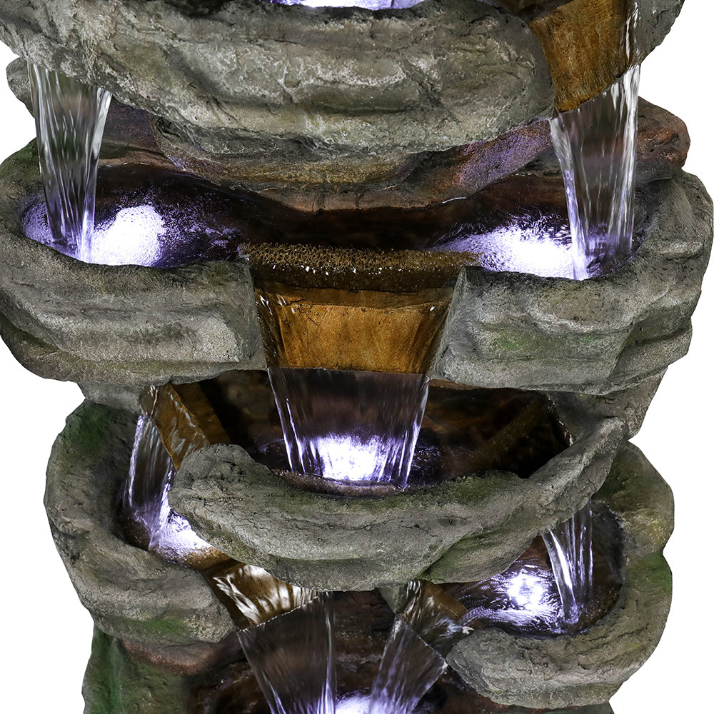 Detailed shot of the water flow trickling through the middle stone layers of the 6-tier waterfall