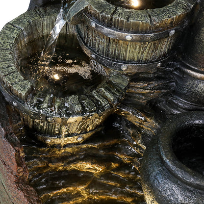 Detailed shot of the water trickling circularly from the middle resin wood barrel