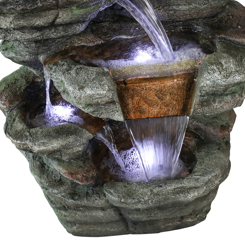 Detailed shot of water elegantly trickling into the warm LED illuminated resin pools