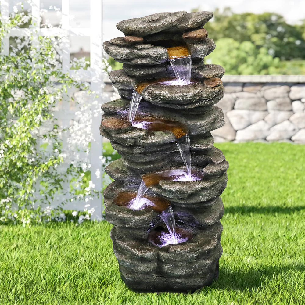 Floor water fountain placed on a fresh green lawn for a refreshing atmosphere