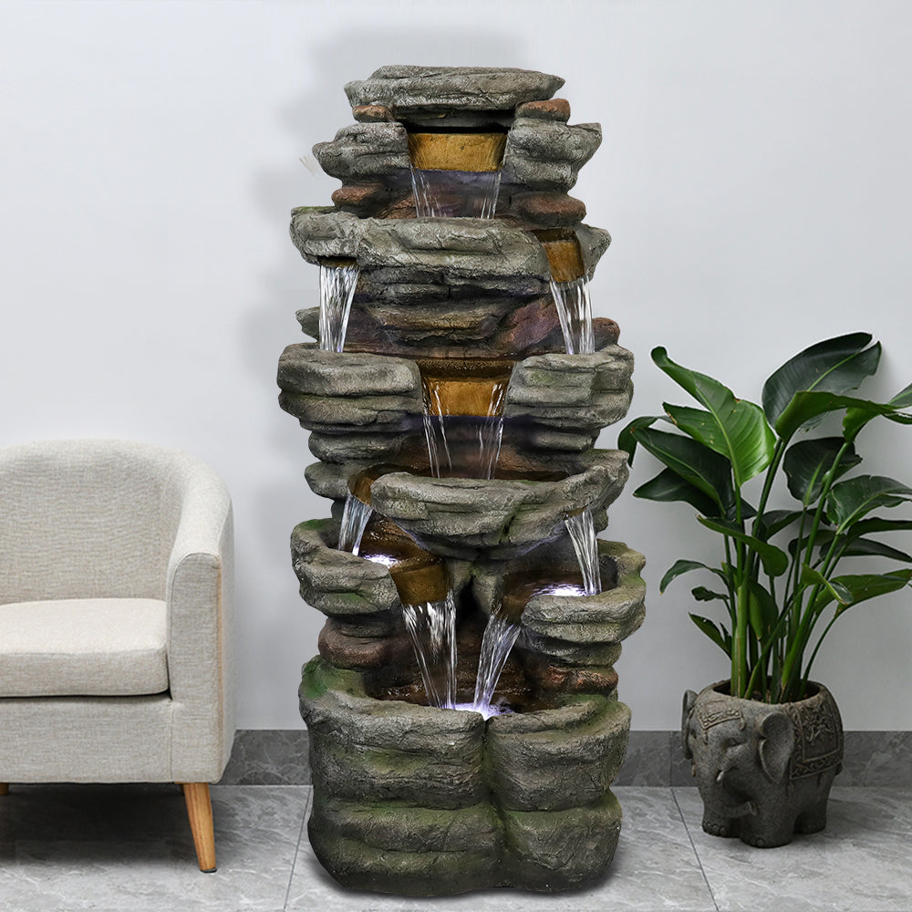 Grand 6-tier rock waterfall fountain creating a welcoming entrance at the front porch