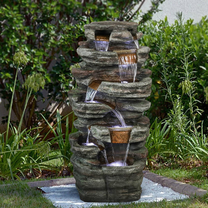 Majestic 48"H 7-tier stacked shale outdoor fountain acting as a focal point on a green lawn