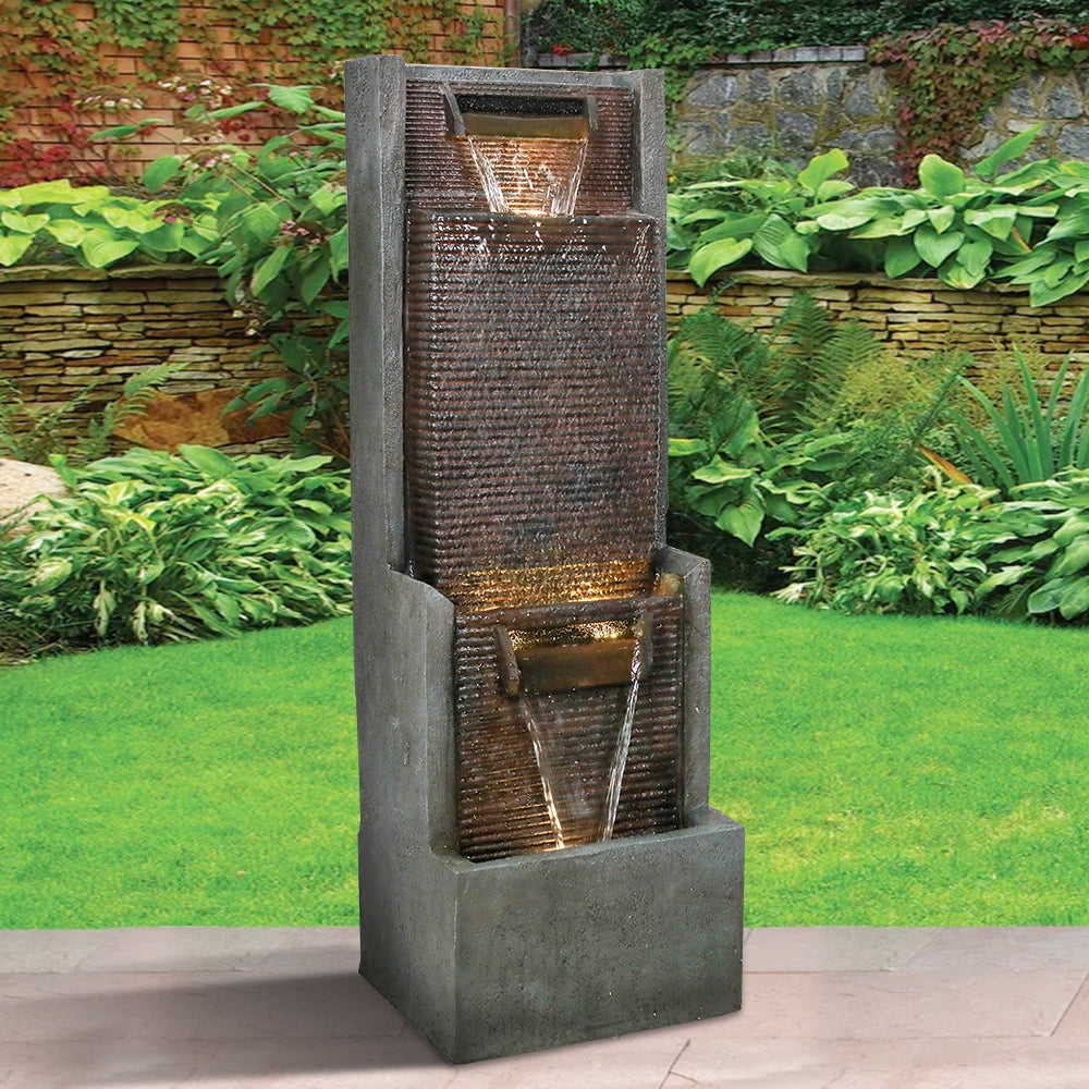 Minimalist modern water feature standing elegantly on a fresh green lawn
