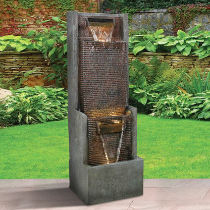 Minimalist modern water feature standing elegantly on a fresh green lawn