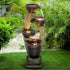 Modern cascading bowls fountain standing elegantly on a lush green lawn