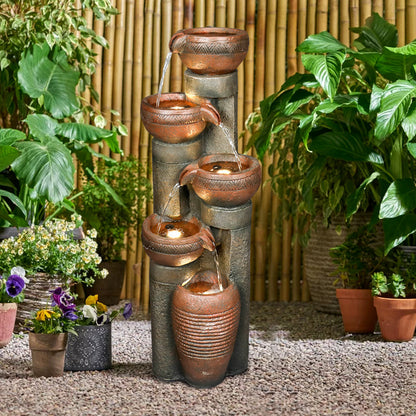 Modern outdoor fountain with warm LED lights illuminating a peaceful backyard
