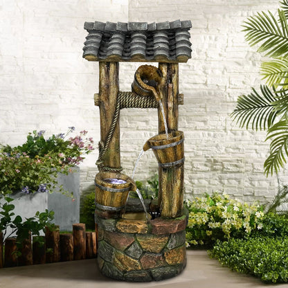 Old-fashioned wishing well fountain with LED lights creating a cozy night in the backyard