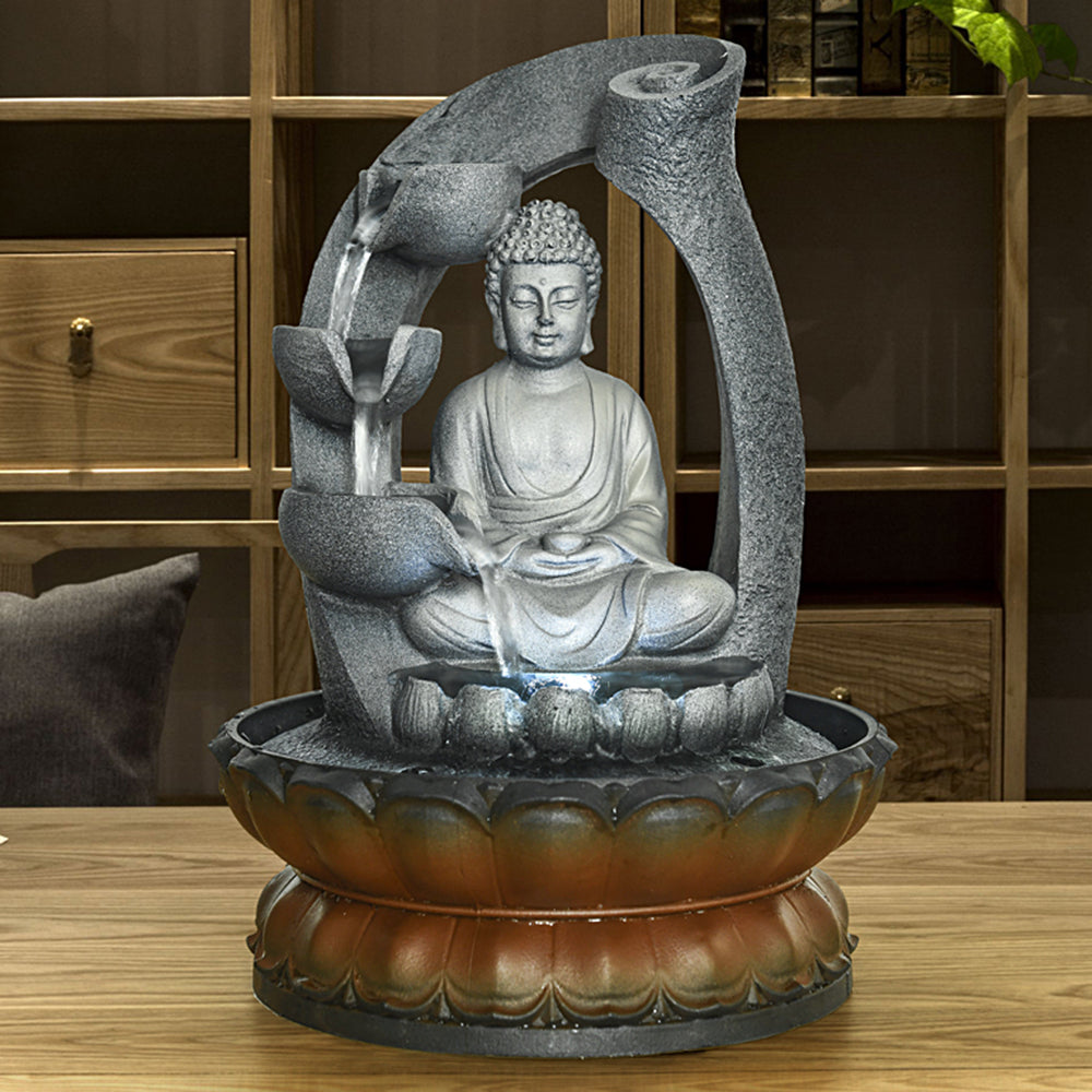 Peaceful resin Buddha water feature with lotus base bringing tranquility to a busy office desk
