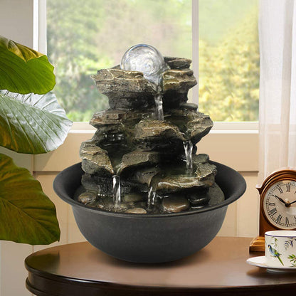 Small 4-tier realistic rock cascading fountain decorating a living room side table