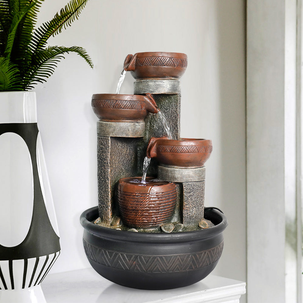 Soothing LED illuminated waterfall fountain on a living room side table