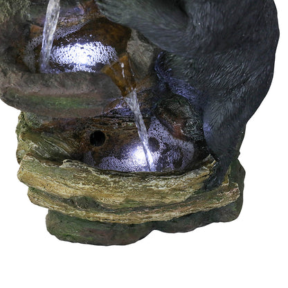 Soothing water flow trickling through the natural wood-textured basins