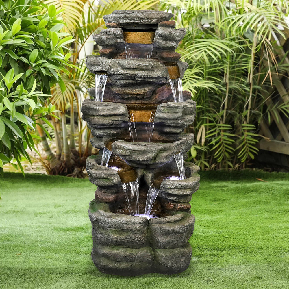 Sturdy outdoor floor fountain standing majestically on a spacious green lawn