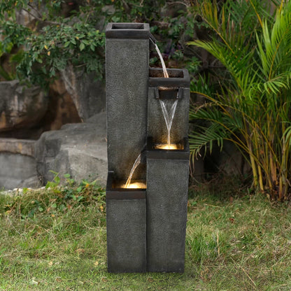 Tall square pillar water feature positioned against a modern minimalist backyard fence